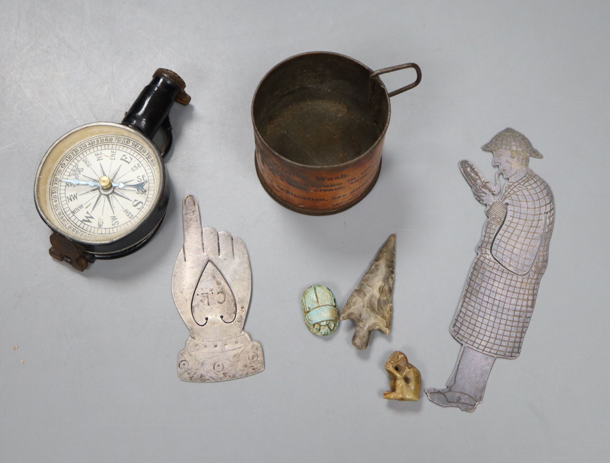 Two novelty bookmarks, compass, flint arrow head, and a collection of coins, etc.